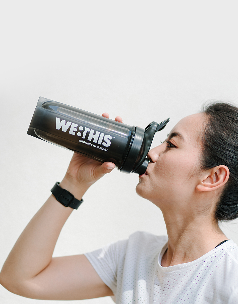 Woman enjoying WE8THIS out of shaker