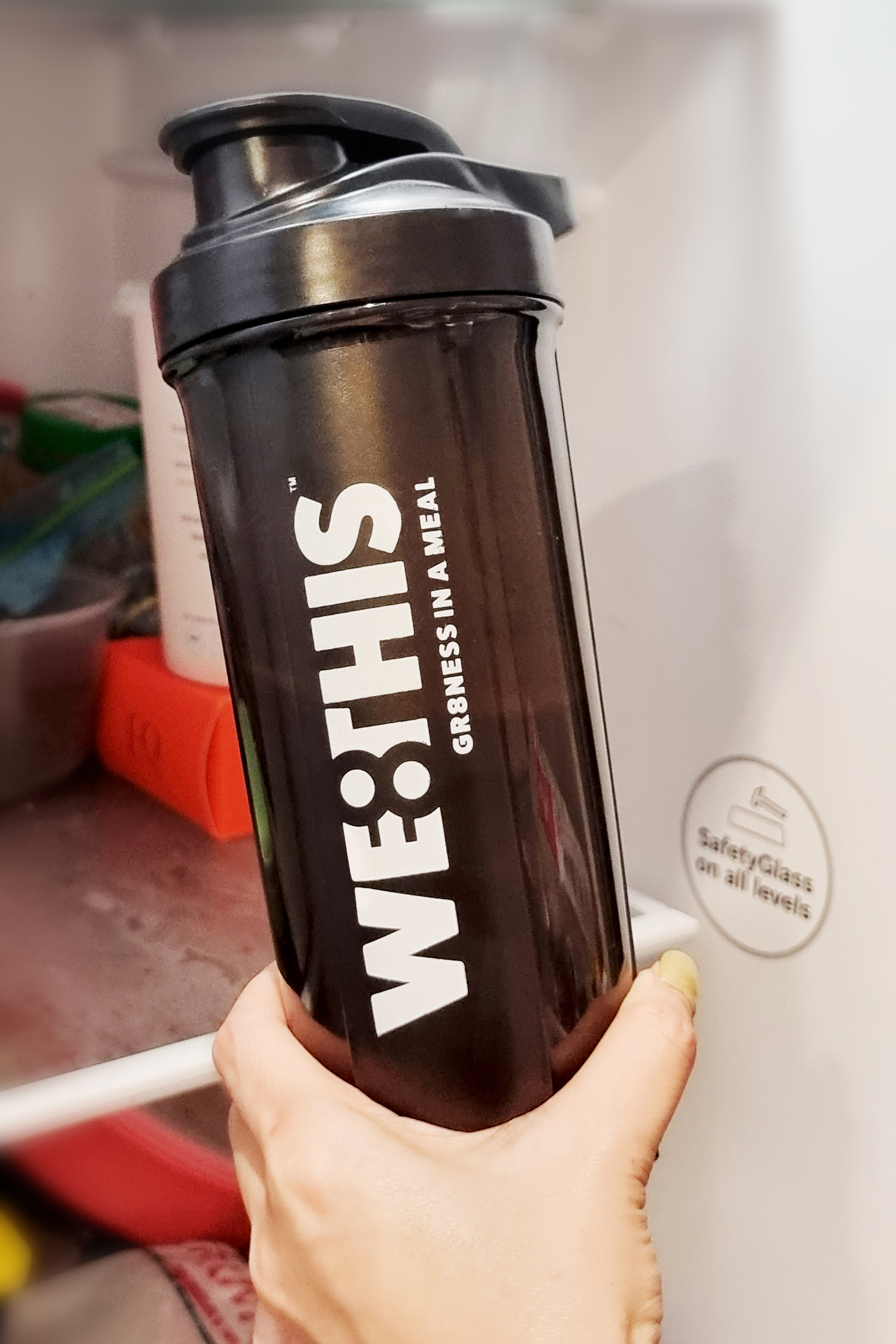 Woman putting WE8THIS shaker in fridge