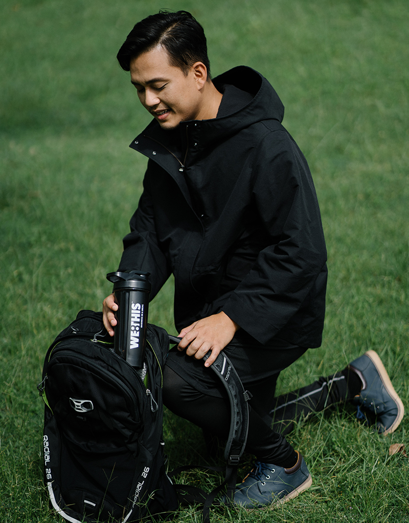 Man keeping WE8THIS shaker in backpack