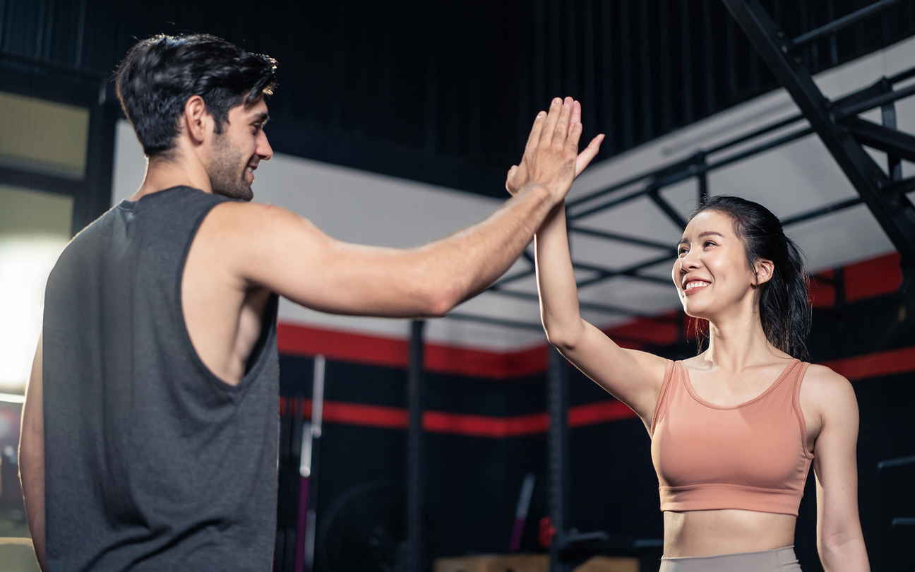Man high-fiving woman post exercise